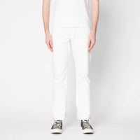 Person wearing white pants and black sneakers on a light gray background